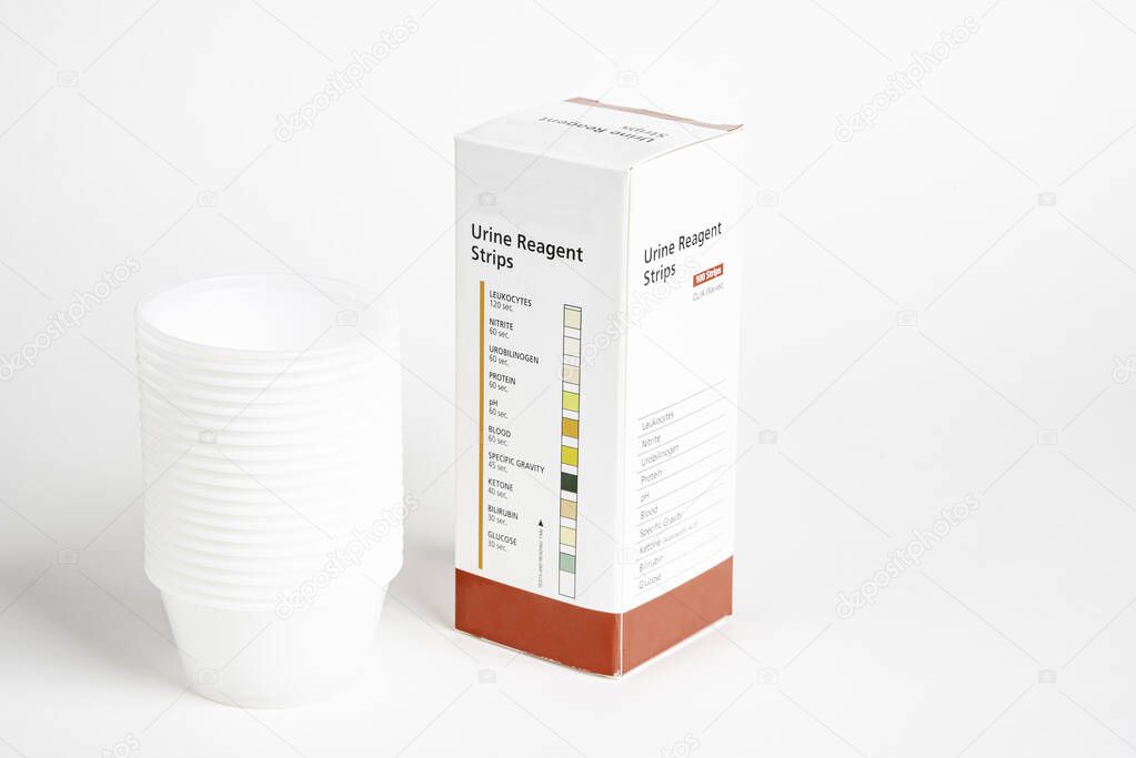 Urine Strips Box And A Stack Of Plastic Containers