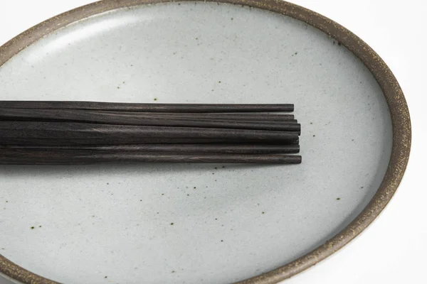 stock image Six Pairs Of Chopsticks On Stoneware Plate