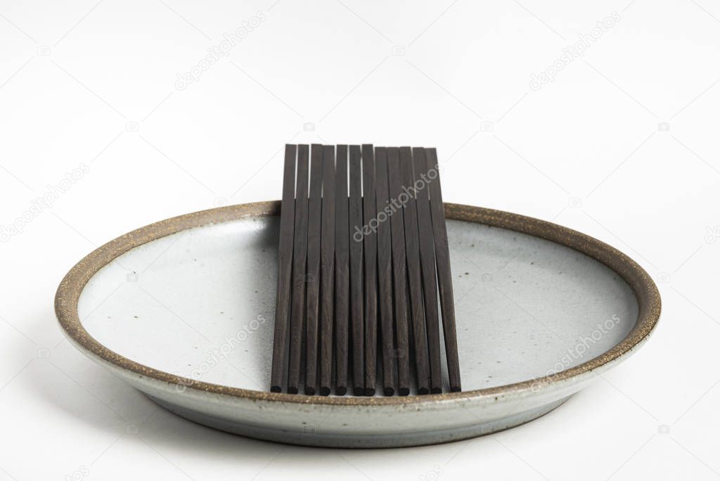 Six Pairs Of Chopsticks On Stoneware Plate