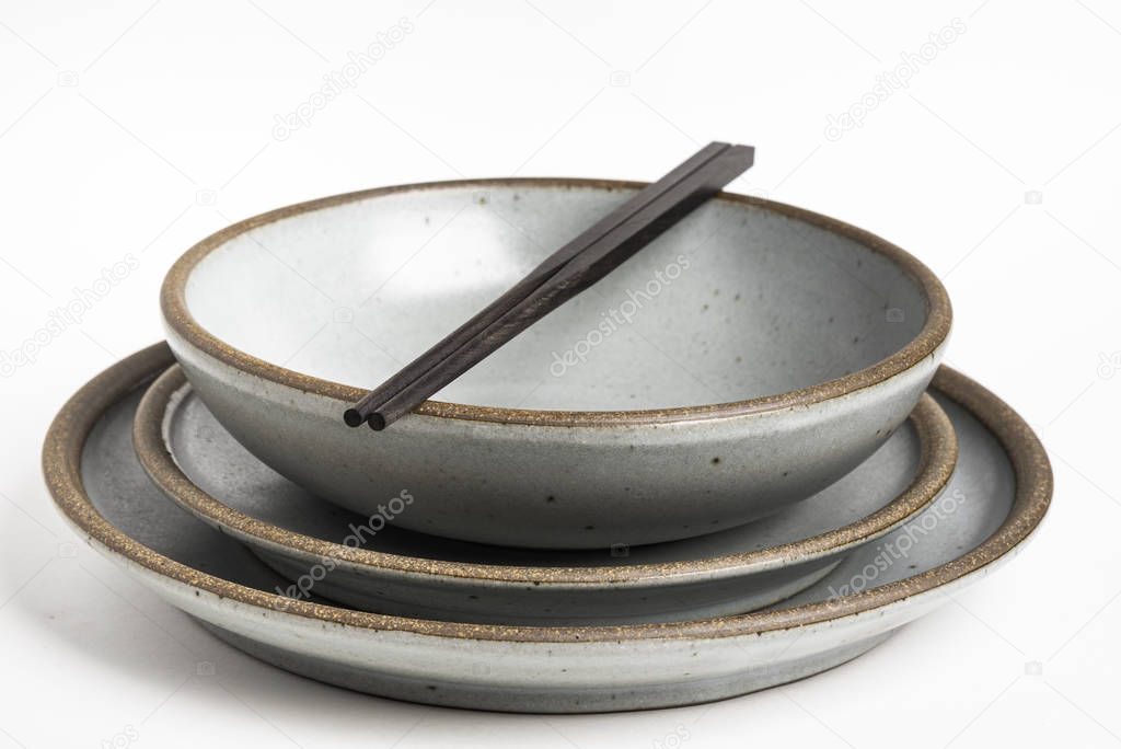 A Pair Of Chopsticks On Stoneware Dinner Set