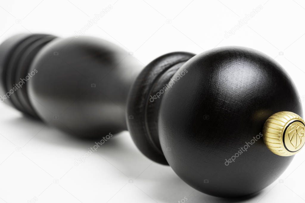 Vidalia, Georgia / USA - June 12, 2019: A stylized extreme macro shot with selective focus on the iconic logo crown of the classic black wood Peugeot pepper grinder.