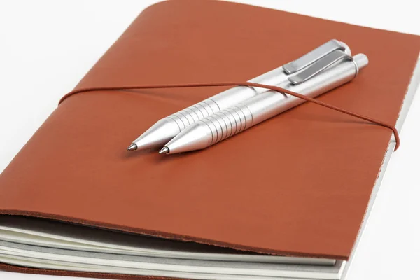 Red Leather Journal Cover with Two Ballpoint Pens — стоковое фото