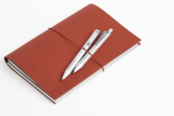 Red Leather Journal Cover with Two Ballpoint Pens — стоковое фото