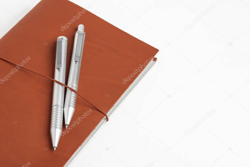 Red Leather Journal Cover With Two Ballpoint Pens