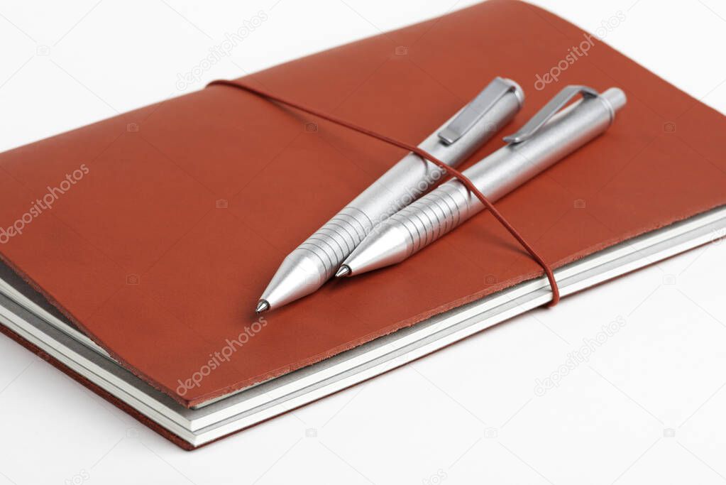 Red Leather Journal Cover With Two Ballpoint Pens