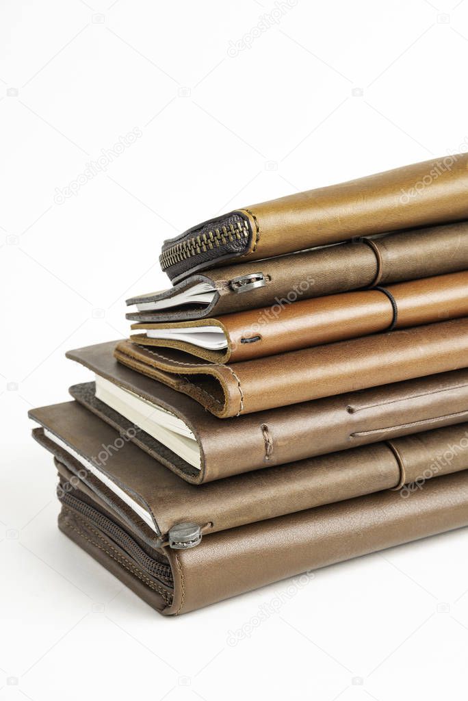 A Stack Of Leather-Bound Journals, Notebooks, Wallets & Cases