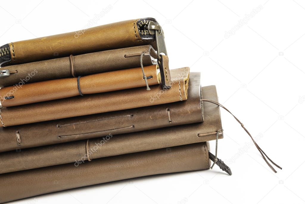 A Stack Of Leather-Bound Journals, Notebooks, Wallets & Cases