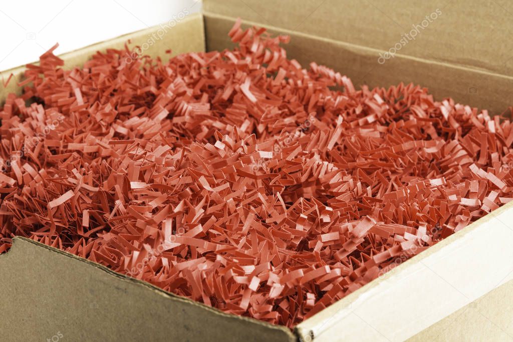 Package Box With Red Paper Strips Filling