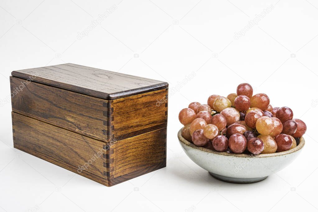 A Bowl Of Fresh Grapes With Japanese Wood Bento Box