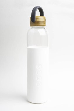 A SOMA Glass Water Bottle With White Sleeve & Grey Handle clipart