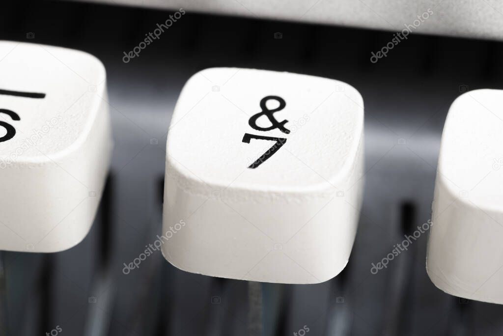 An extreme close-up or macro shot of a plastic keyboard key from a manual typewriter with shallow depth of field and selective focus.