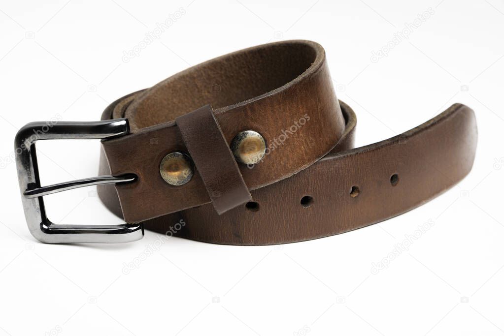 A formal studio product shot of a men's used brown leather belt with patina set on plain white background.