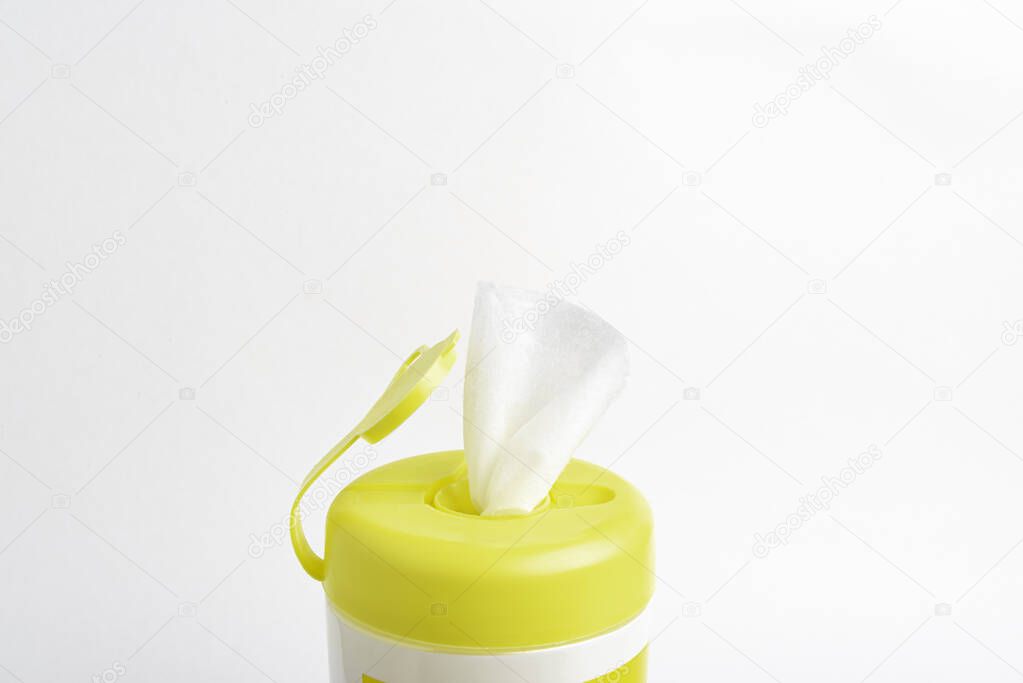 A close-up shot of an open yellow push top cap of a disinfectant wet wipes product container set on plain white background.