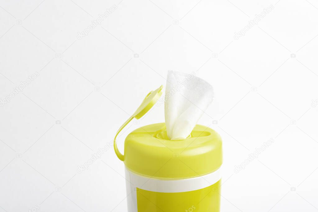 A close-up shot of an open yellow push top cap of a disinfectant wet wipes product container set on plain white background.