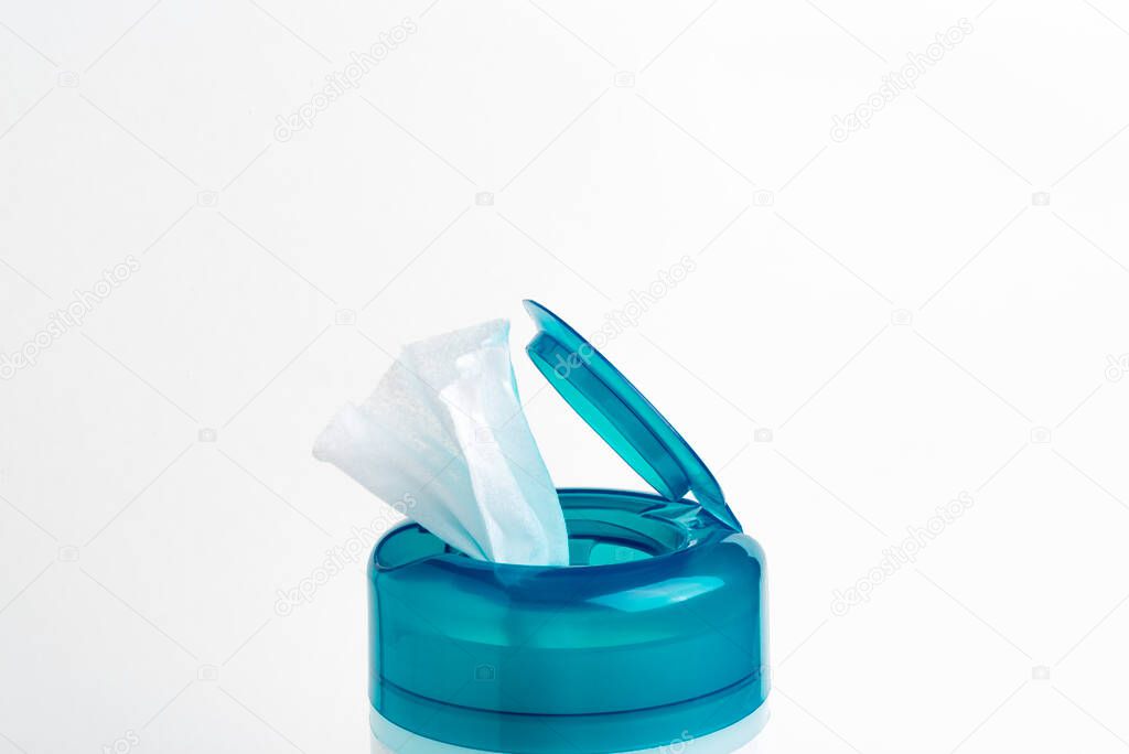 A close-up shot of an open aquamarine push top cap of a disinfectant wet wipes plastic container set on a plain white background.