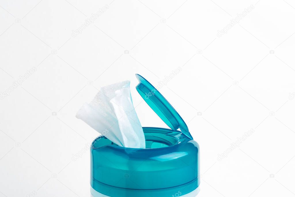 A close-up shot of an open aquamarine push top cap of a disinfectant wet wipes plastic container set on a plain white background.