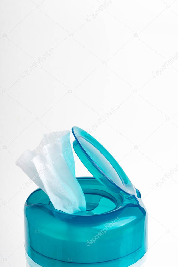 A close-up shot of an open aquamarine push top cap of a disinfectant wet wipes plastic container set on a plain white background.
