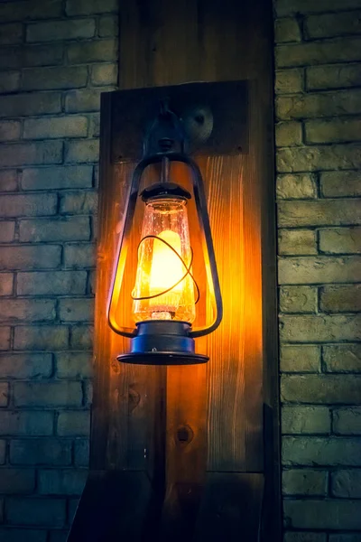 Lamp in the old style on the wall. Restaurant interior in the morning.