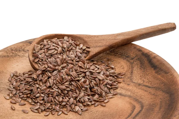 Colher e prato com sementes de linho — Fotografia de Stock