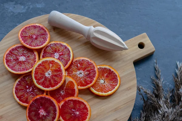 Red orange source of vitamins on a wooden board