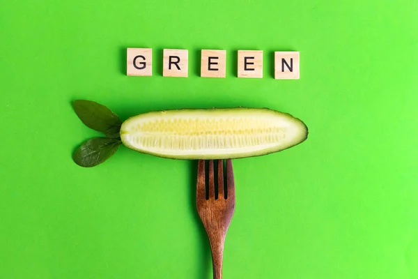 Letters Vegan Vegan Healthier Eco Cucumber Wooden Fork Green Background — Stock Photo, Image