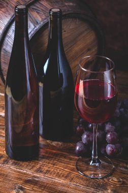 Wine Glass and Bottles with Grapes