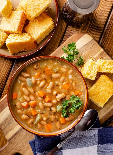 Overhead View Tasty Bean Soup Carrots Celery Bowl Cornbread Wooden — Stock Photo, Image