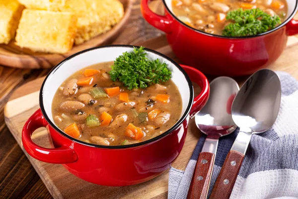 Tasty Bean Soup Vegetables Red Bowl Cornbread Background Wooden Table — Stock Photo, Image