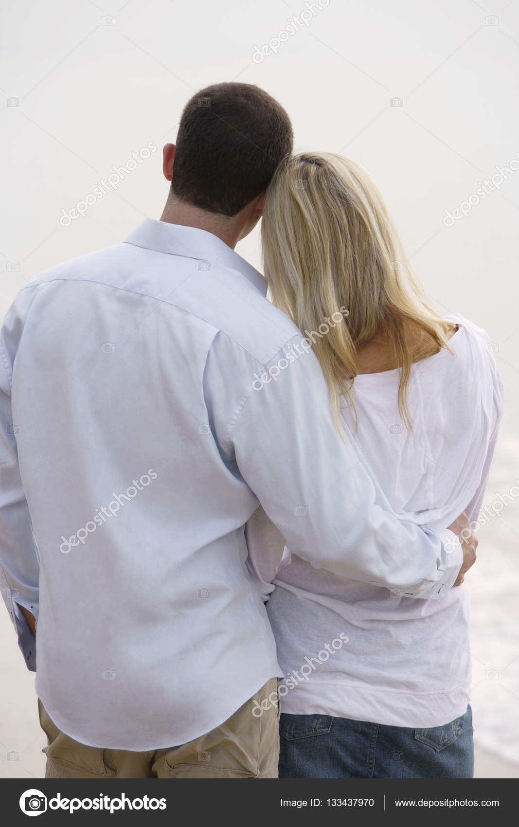 Back View Of Couple Standing Arm In Arm Stock Photo Image By C Microstockasia