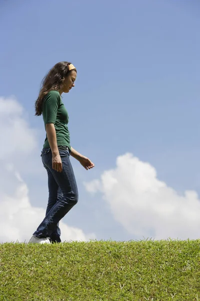 Adolescente chica caminando en hierba — Foto de Stock