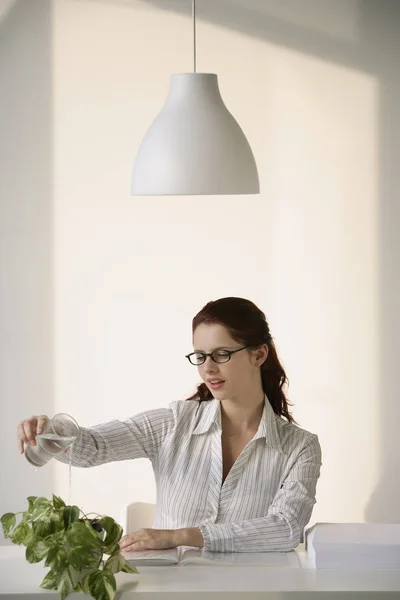 Woman watering plant