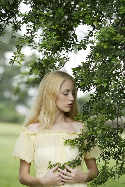 Frau in gelbem Kleid im grünen Feld — Stockfoto