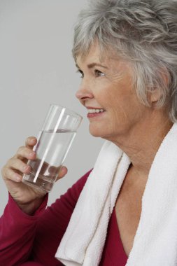 Mature woman drinking water clipart