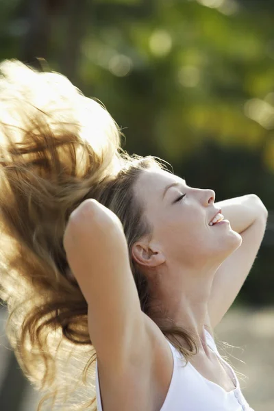 woman tossing hair back