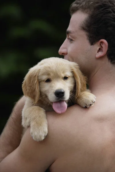 Man with puppy on nature — Stock Photo, Image