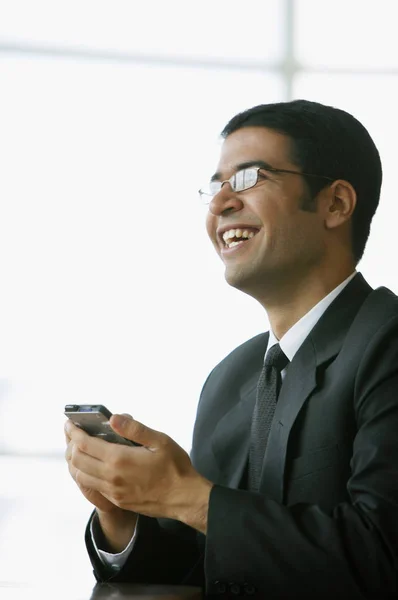 Businessman holding PDA — Stock Photo, Image