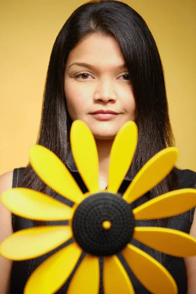 Young woman against yellow background — Stock Photo, Image