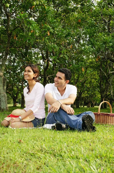 Paar sitzt auf Gras — Stockfoto