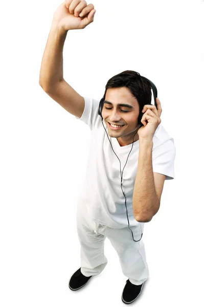 Young man listening to headphones — Stock Photo, Image