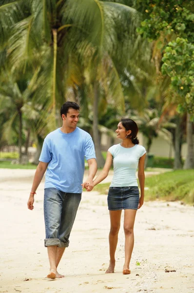 Пара гуляє вздовж пляжу — стокове фото
