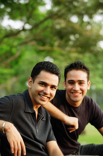 Two men sitting side by side