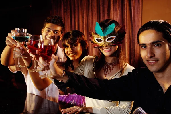 Couples at bar, toasting Stock Picture