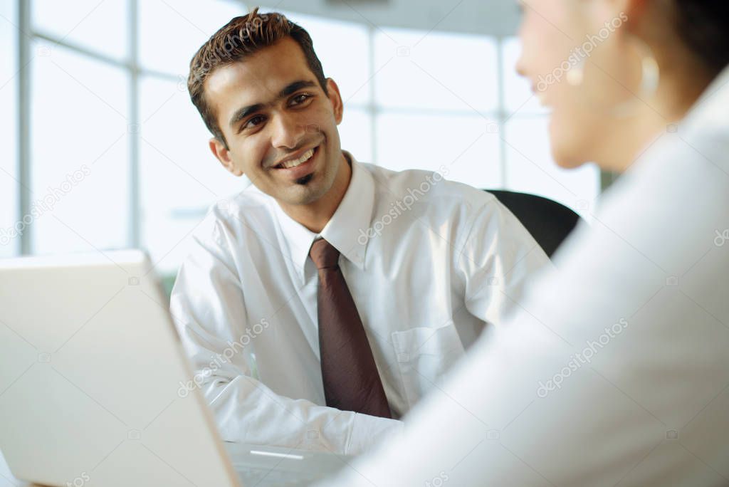 Executive smiling at another person 