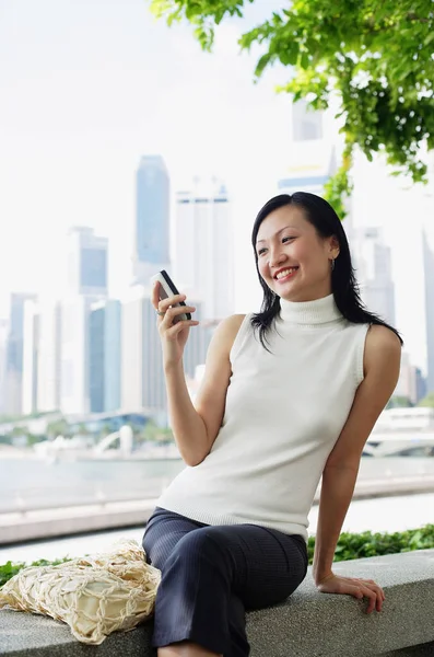 Young woman, looking at mobile phone