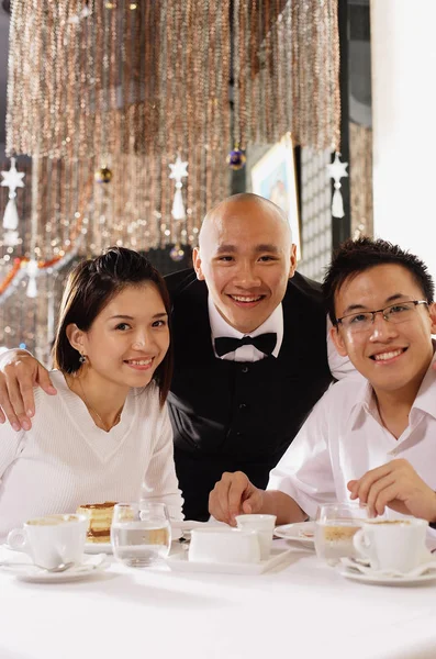 Waiter and customers at restaurant