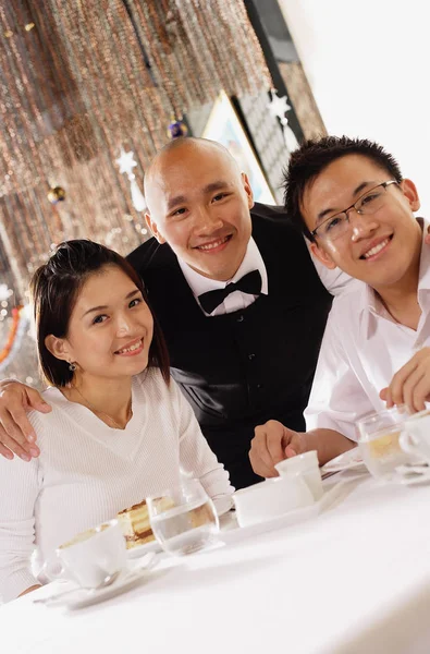 Waiter and customers at restaurant