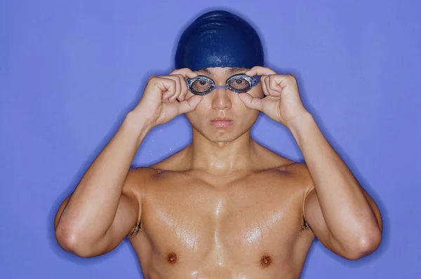 Man in swimming cap and goggles