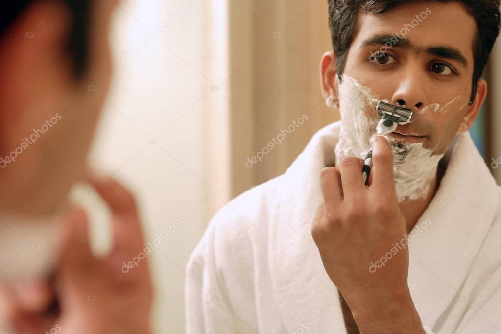 Man shaving his face