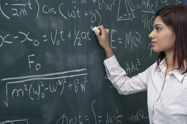 Teacher against chalk board — Stock Photo, Image