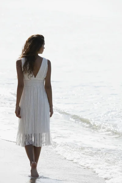 back view of woman wearing a white dress